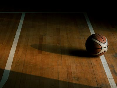 Sport equipment lying on a dark floor in a studio.